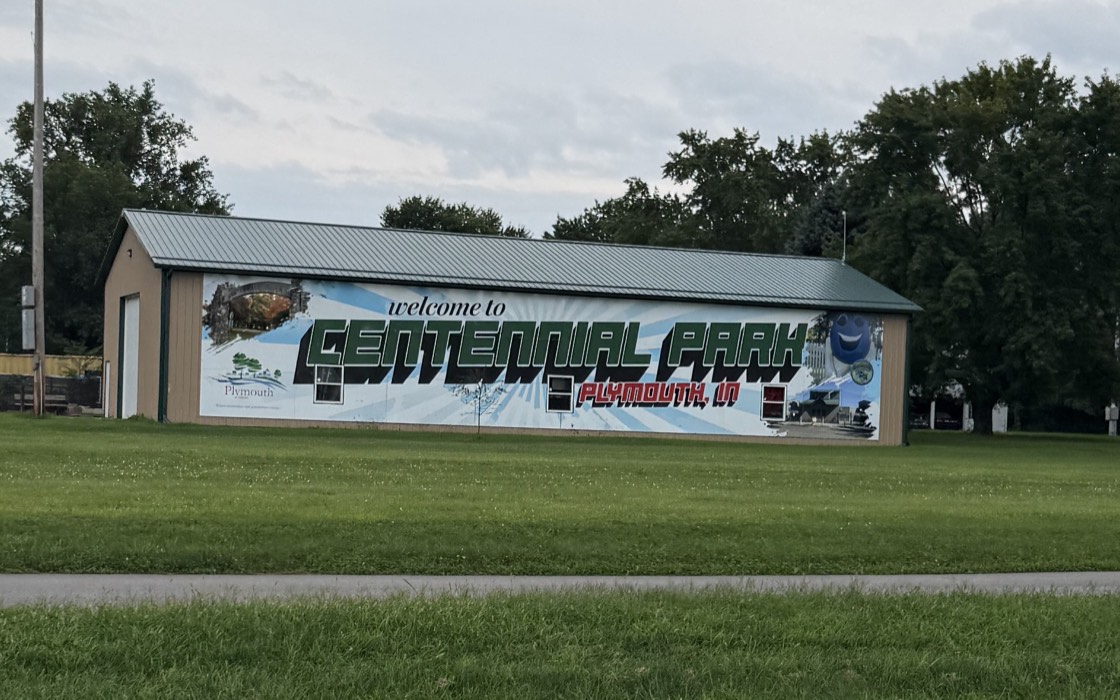A large-format exterior wall wrap on a building in Plymouth, Indiana.