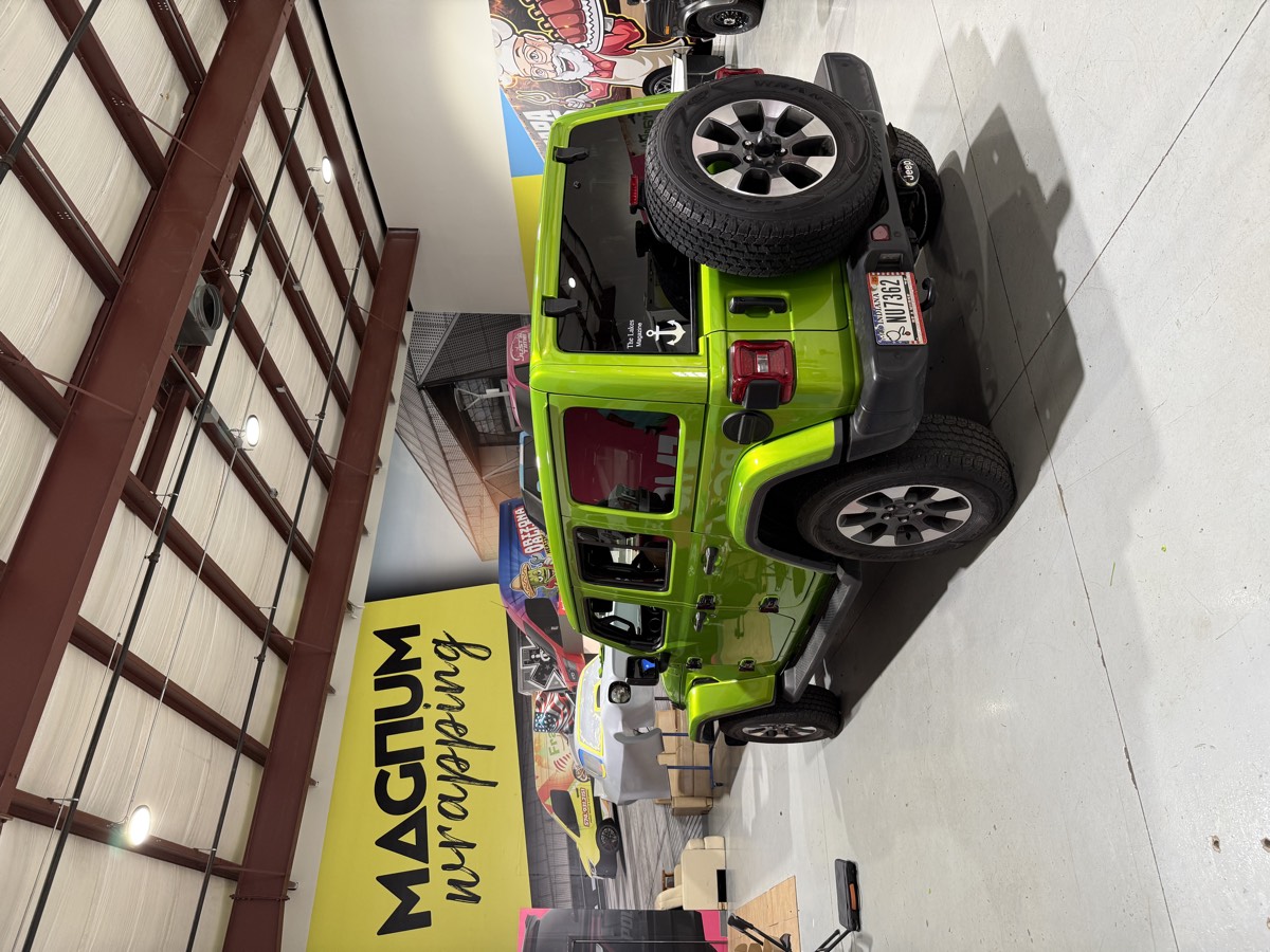 Gloss green color-change wrap on a Jeep Wrangler.