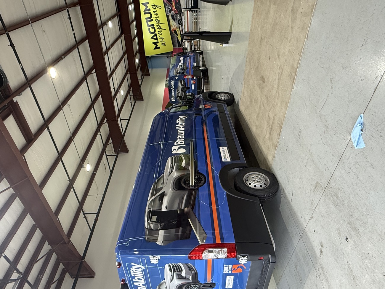 Blue BraunAbility van fleet inside the shop.