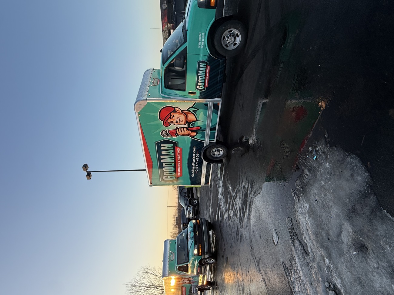 Two wrapped service vehicles for Goodman Plumbing & Heating.