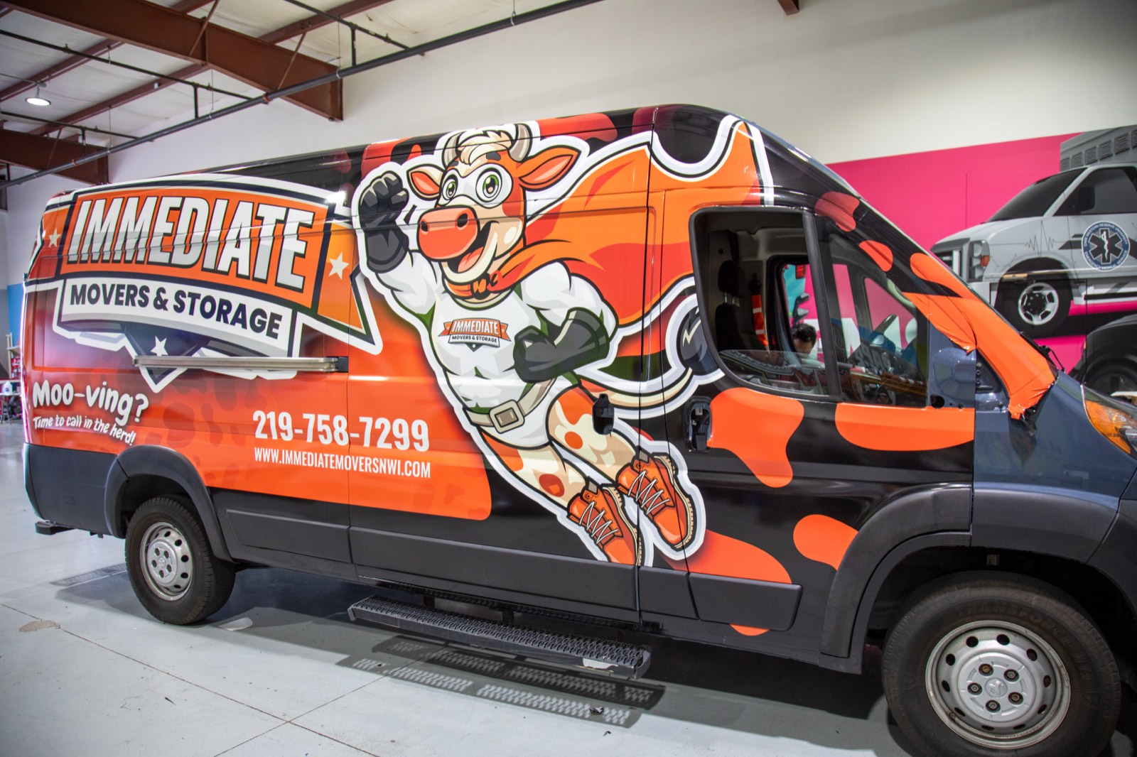 Camo-and-orange cargo van wrap for Immediate Movers