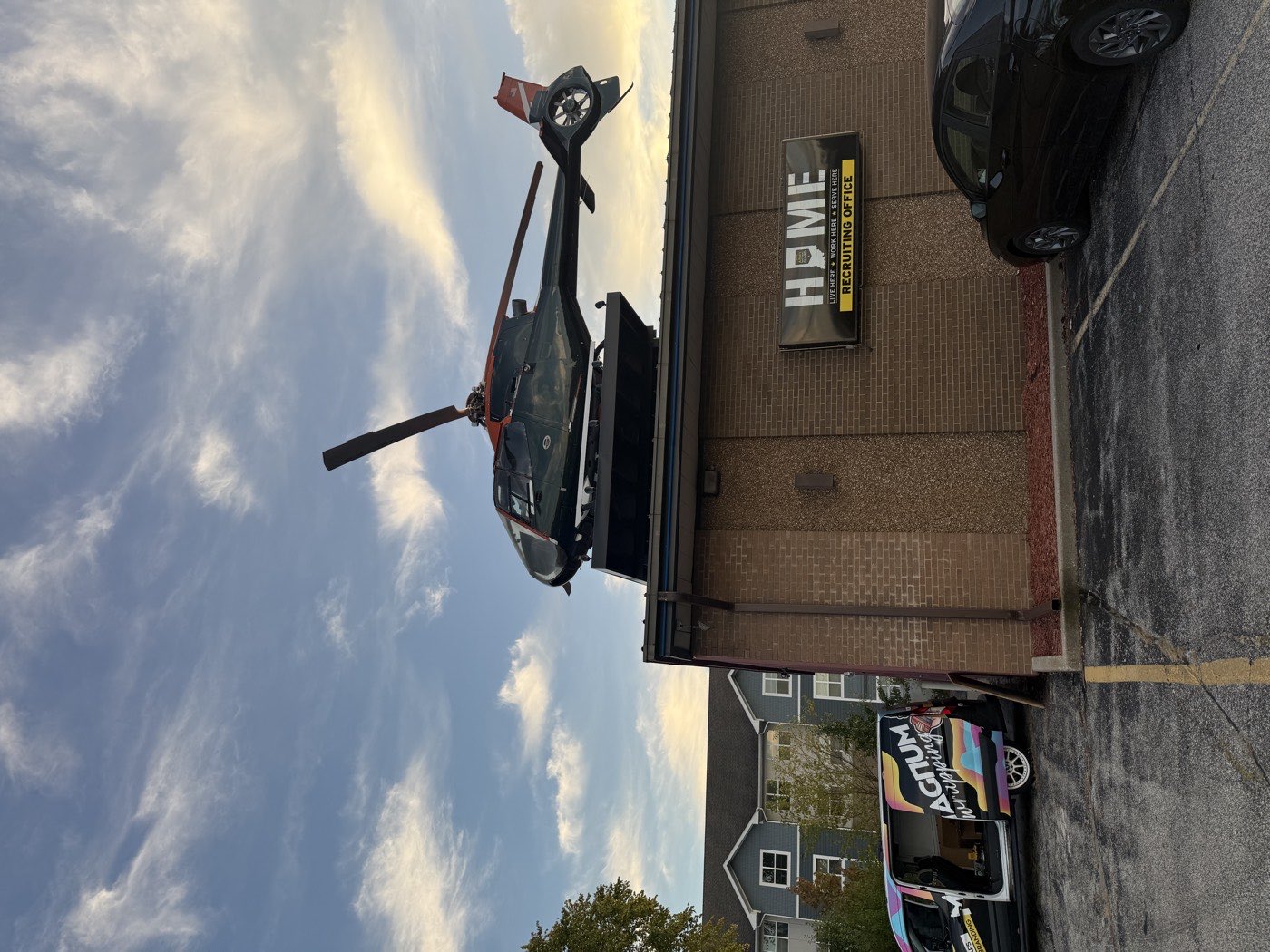 A wrapped display helicopter mounted on the roof of a military recruiting office.