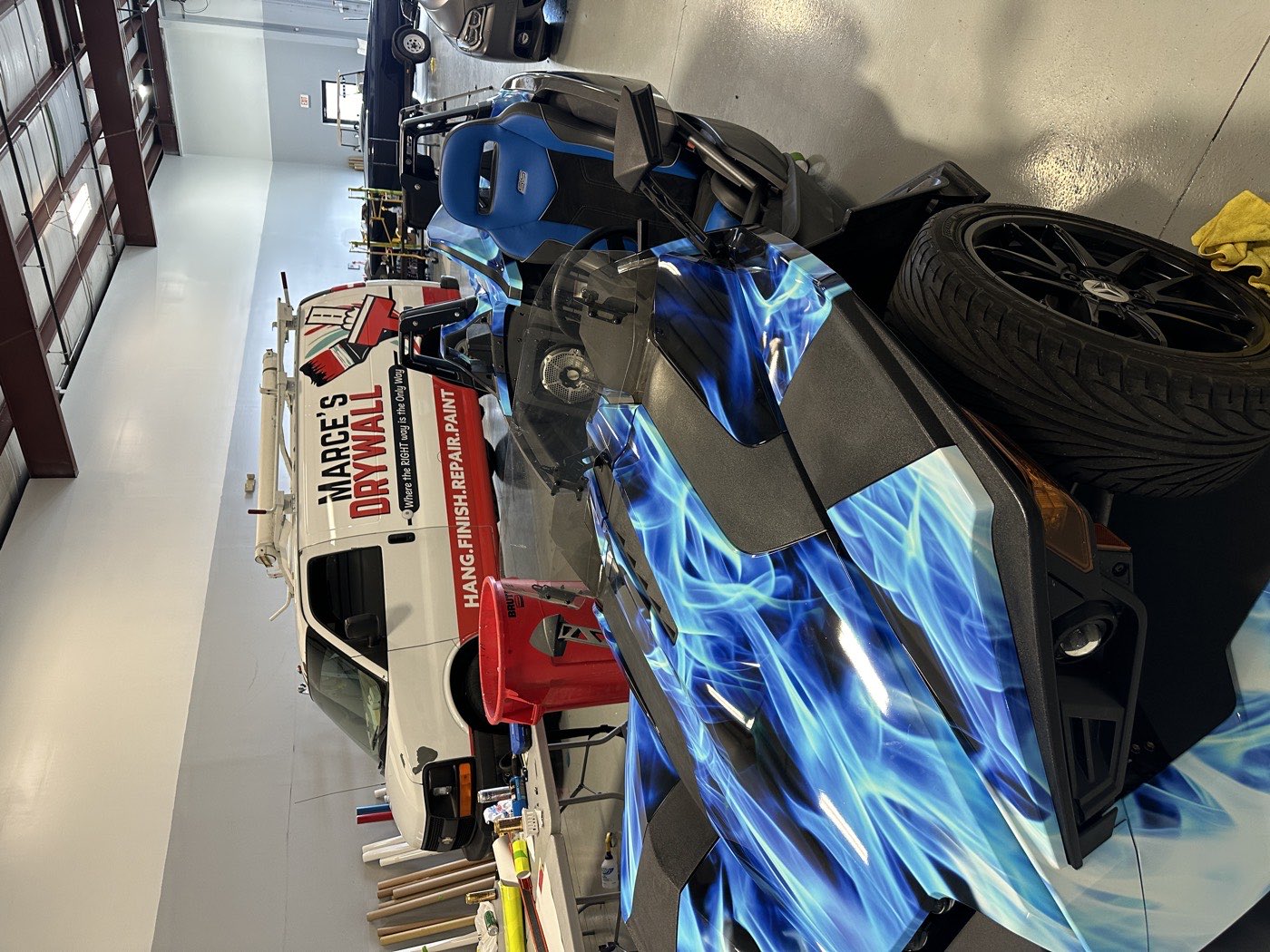 Blue-flame custom wrap on a Polaris Slingshot.