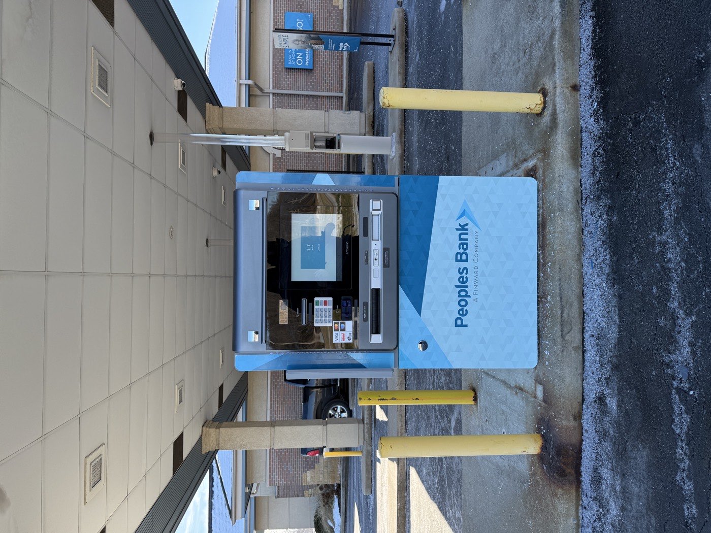 Drive-up ATM kiosk wrapped in Peoples Bank branding.